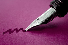 fountain pen writing on rose-colored paper